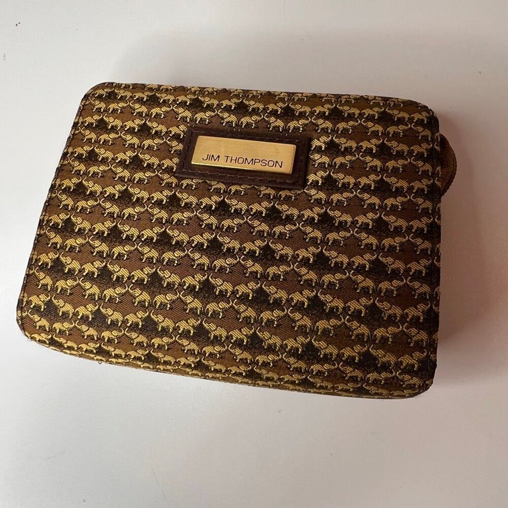 Jim Thompson coin bag featuring a repeating elephant pattern on brown Thai silk